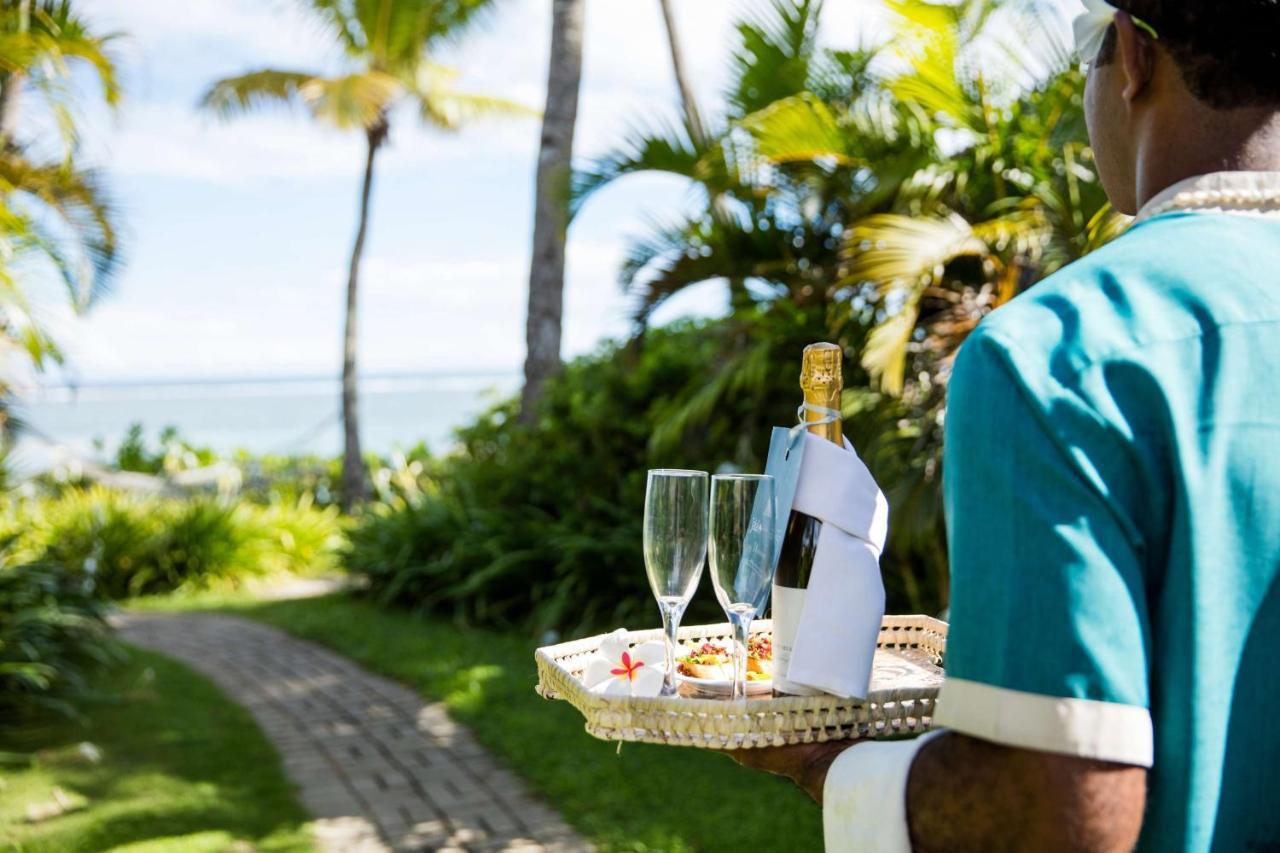 Outrigger Fiji Beach Resort Korotogo Extérieur photo A butler at the Four Seasons Resort Maldives at Landaa Giraavili